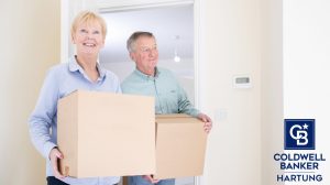 Retiree couple with moving boxes